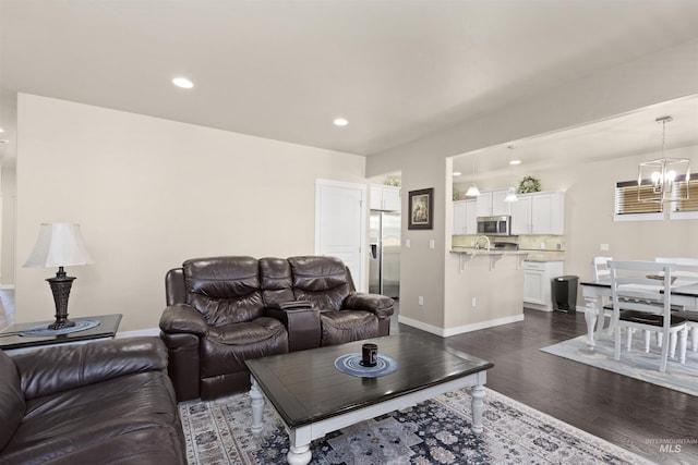 5359 N Landon Creek Pl, Meridian, ID 83646 - living room featuring baseboards, recessed lighting, a chandelier, and dark wood-style flooring