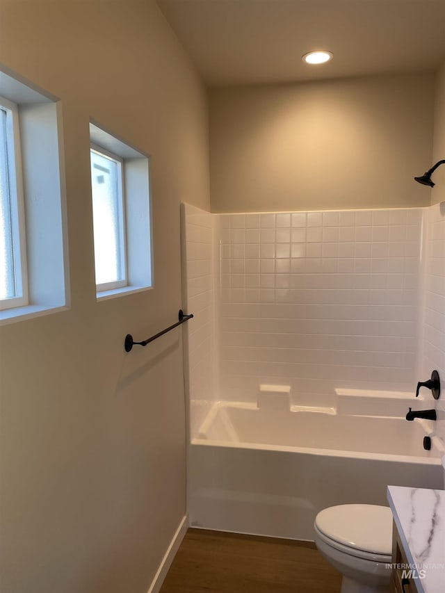 full bath with toilet, wood finished floors, bathtub / shower combination, vanity, and recessed lighting