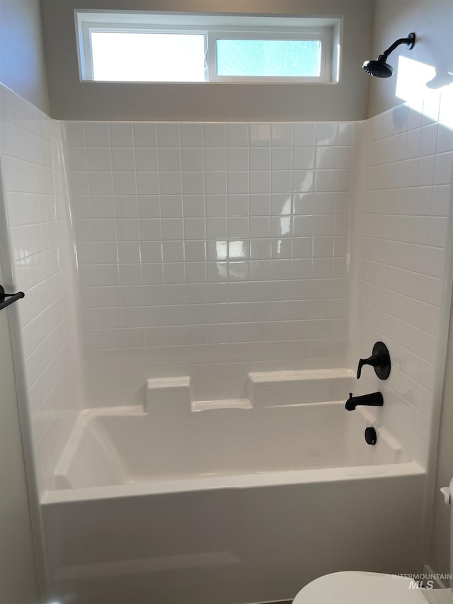 full bath featuring a wealth of natural light, shower / bath combination, and toilet