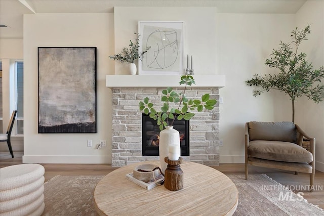 3527 E Warm Springs Ave, Boise, ID 83716 - sitting room with wood finished floors, baseboards, and a stone fireplace