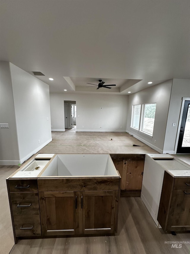 941 Gregory Way, Twin Falls, ID 83301 - kitchen with a raised ceiling, wood finished floors, dark brown cabinetry, and recessed lighting