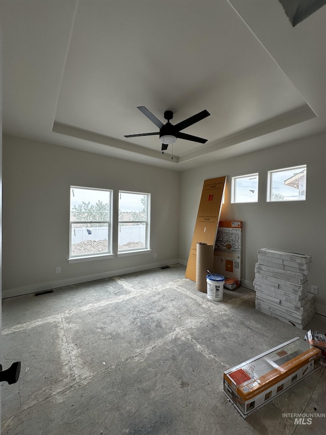 941 Gregory Way, Twin Falls, ID 83301 - unfurnished bedroom featuring a tray ceiling, ceiling fan, and baseboards