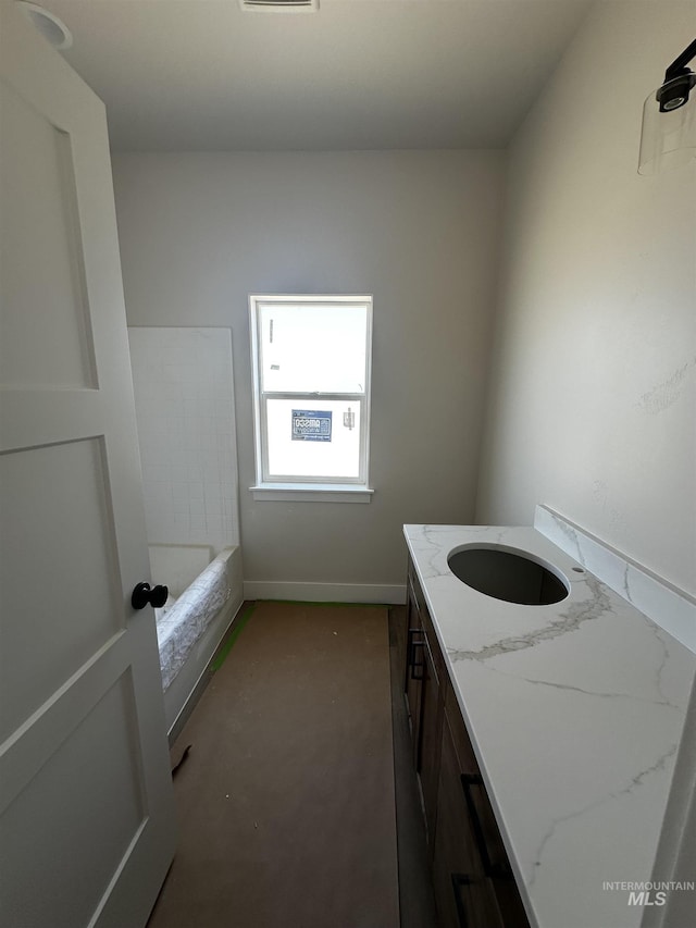 941 Gregory Way, Twin Falls, ID 83301 - full bathroom featuring vanity, a tub, and baseboards