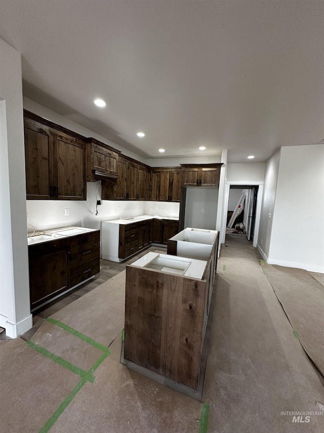941 Gregory Way, Twin Falls, ID 83301 - kitchen featuring dark brown cabinets, recessed lighting, a center island, and baseboards
