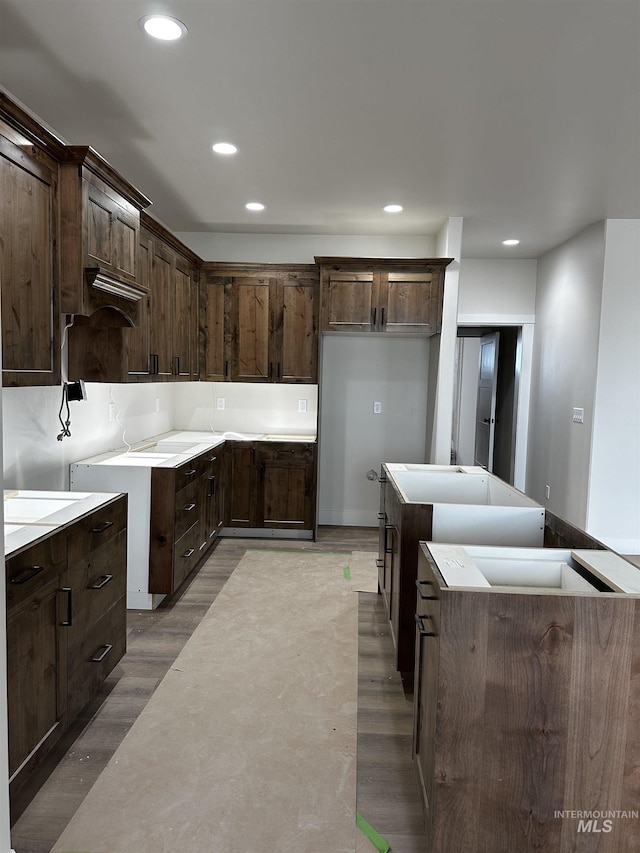 941 Gregory Way, Twin Falls, ID 83301 - kitchen featuring recessed lighting, dark brown cabinets, light wood-style floors, and a center island