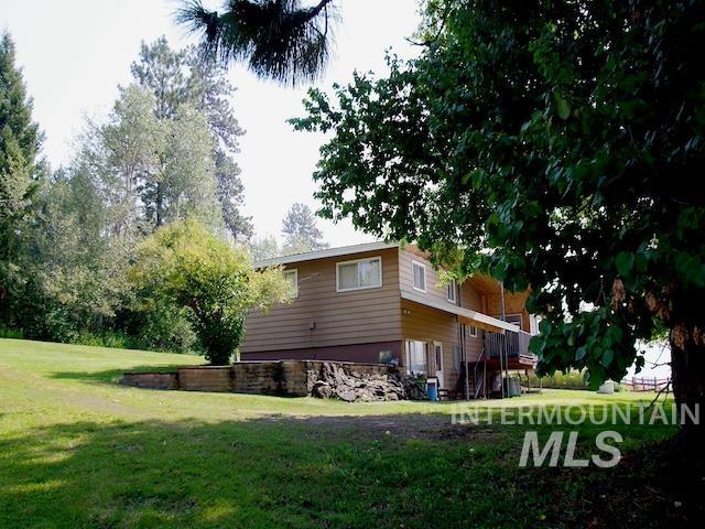 view of property exterior featuring a lawn