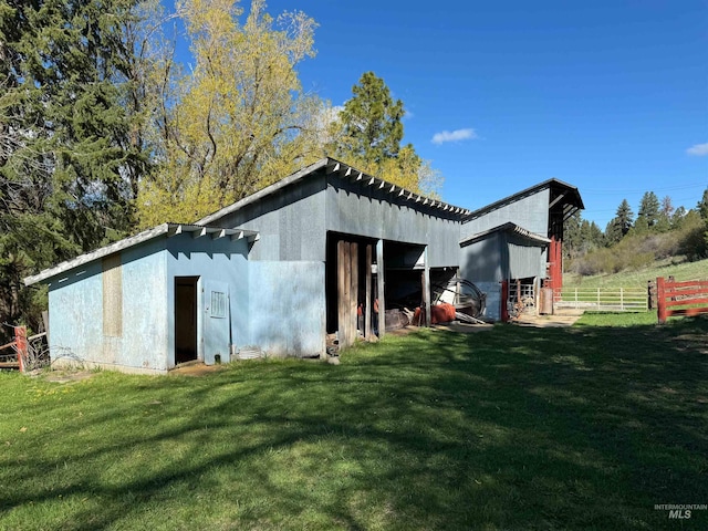 view of outbuilding with a yard