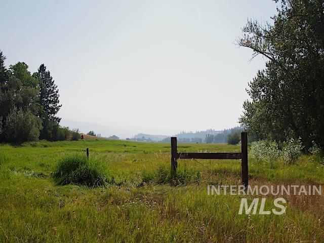 view of gate with a rural view