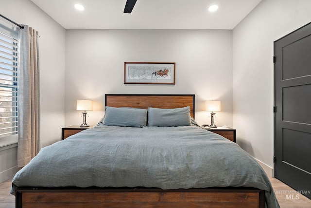 bedroom featuring wood finished floors, a ceiling fan, and recessed lighting