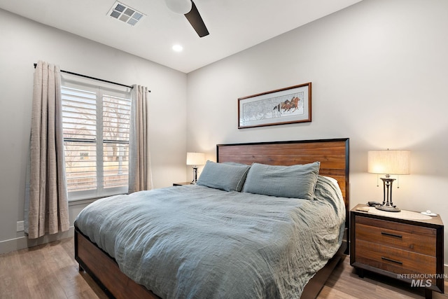 bedroom with recessed lighting, visible vents, a ceiling fan, wood finished floors, and baseboards