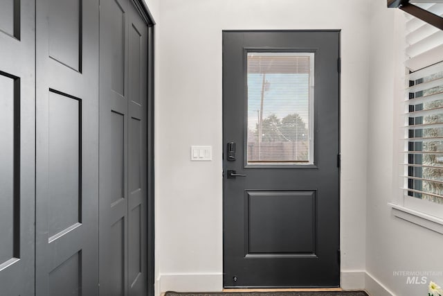 entryway featuring baseboards