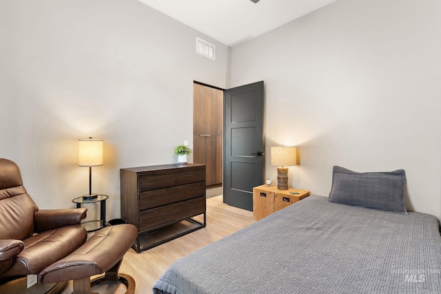 bedroom featuring light wood finished floors and visible vents