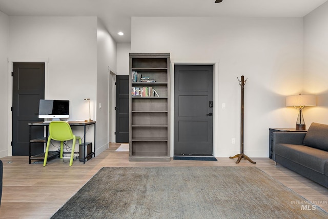 home office with baseboards, wood finished floors, and recessed lighting