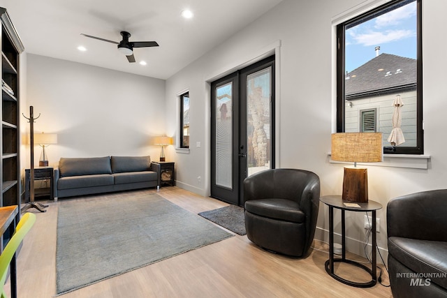 living room featuring recessed lighting, baseboards, wood finished floors, and french doors