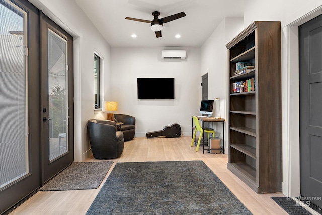 interior space with recessed lighting, plenty of natural light, light wood-style flooring, and a wall mounted AC