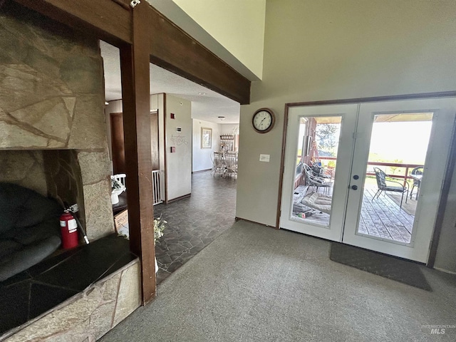 170 Red Fir, Kooskia, ID 83539 - doorway with a fireplace, carpet, french doors, and a towering ceiling