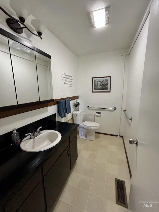 170 Red Fir, Kooskia, ID 83539 - half bathroom featuring toilet, visible vents, and vanity