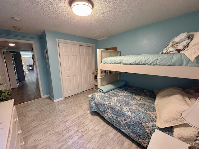 170 Red Fir, Kooskia, ID 83539 - bedroom with a closet, baseboards, a textured ceiling, and wood finished floors