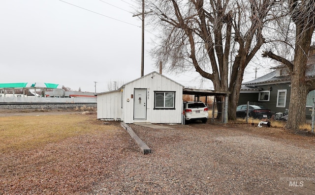 view of outbuilding with a carport and driveway