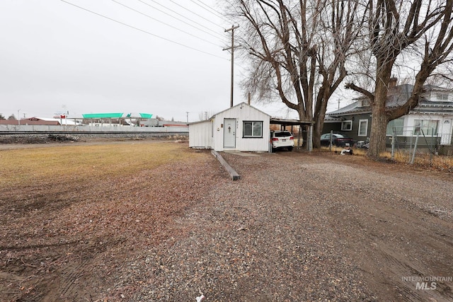 view of front of property featuring driveway and an outbuilding