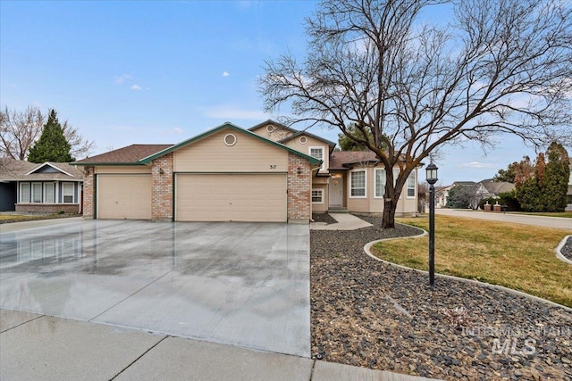 view of front of home with brick siding, a front lawn, concrete driveway, and an attached garage