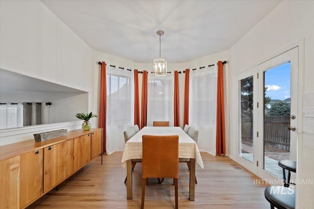 dining room featuring light wood-style floors and a chandelier