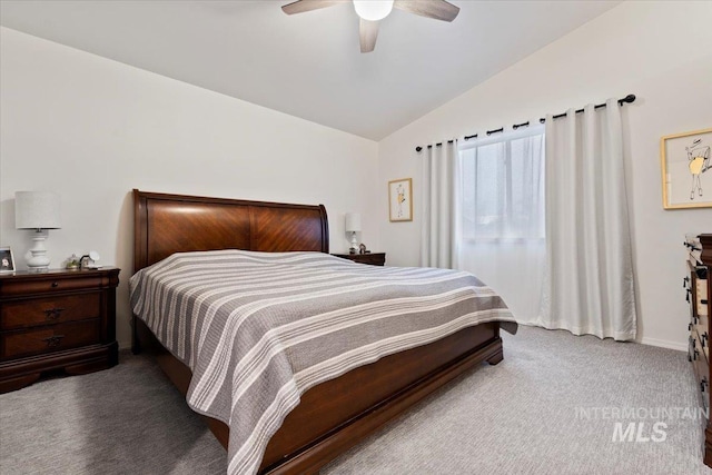 bedroom with baseboards, carpet flooring, a ceiling fan, and lofted ceiling