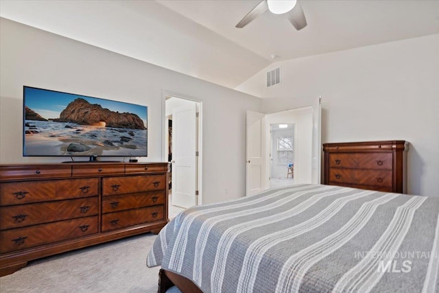 bedroom featuring light carpet, visible vents, ceiling fan, and vaulted ceiling