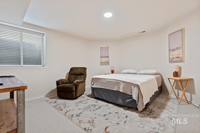 bedroom featuring baseboards and light colored carpet