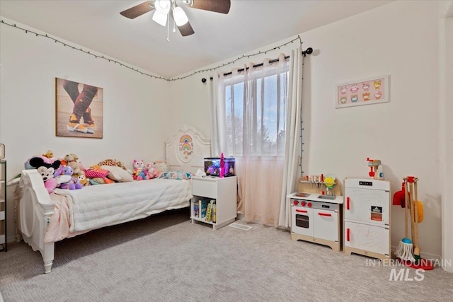 bedroom with a ceiling fan and light carpet