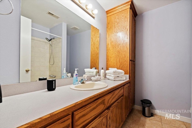 bathroom with vanity, tile patterned floors, visible vents, and walk in shower