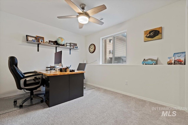 carpeted office with a ceiling fan, visible vents, and baseboards