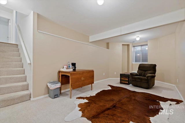 sitting room featuring baseboards, stairs, and carpet