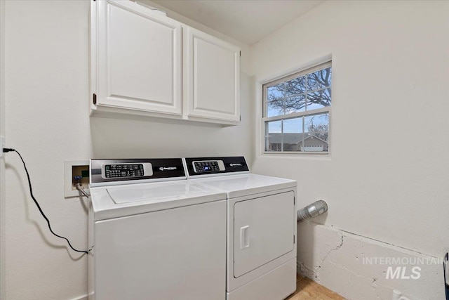 laundry room featuring washer and clothes dryer and cabinet space