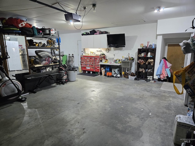 garage with a workshop area and a garage door opener