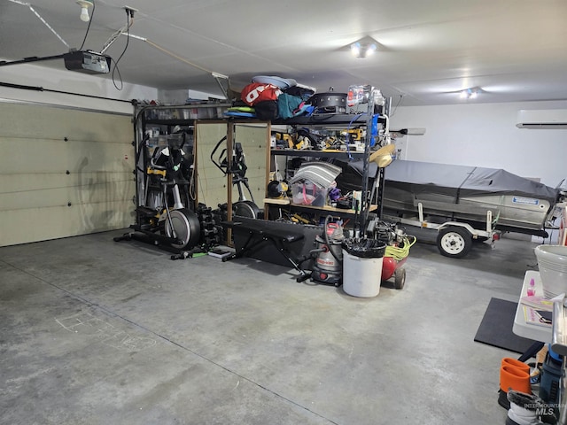 garage featuring an AC wall unit and a garage door opener