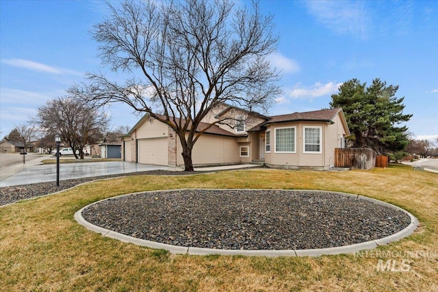 ranch-style home featuring a garage, driveway, and a front lawn