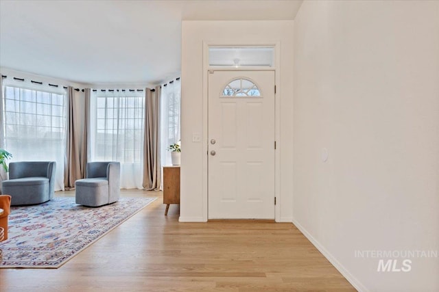 foyer featuring light wood-type flooring and baseboards