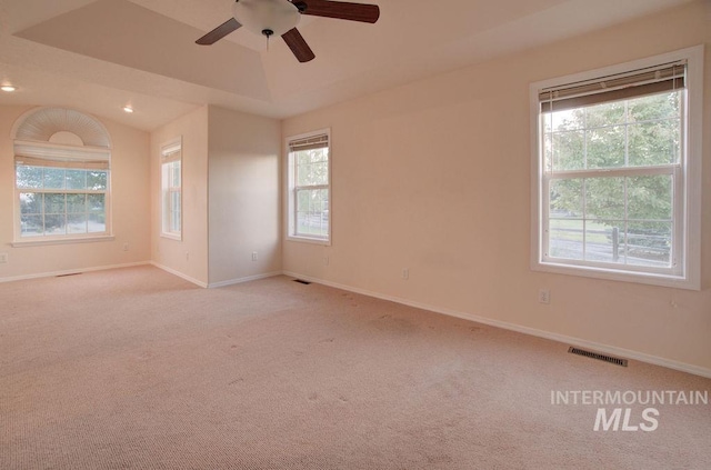 carpeted spare room featuring lofted ceiling and ceiling fan