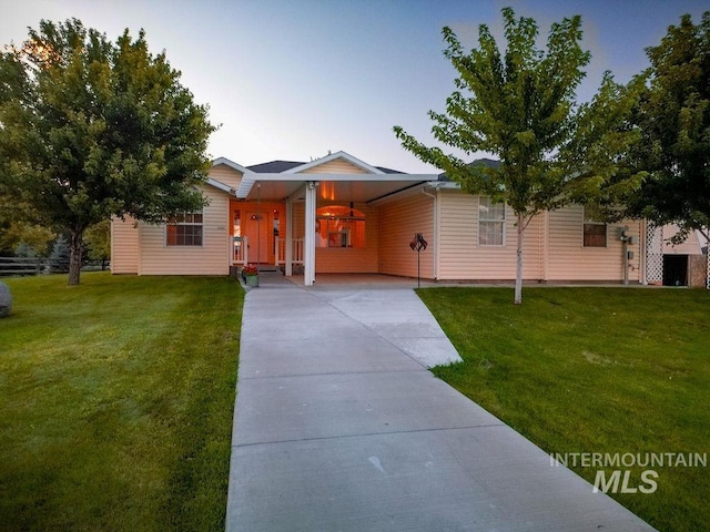 view of front of property with a front yard and a carport