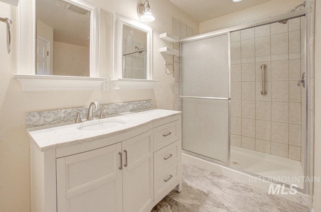 bathroom with vanity and an enclosed shower