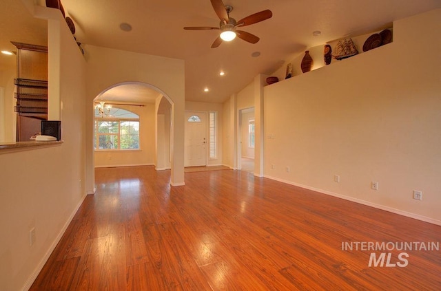 unfurnished room with ceiling fan, wood-type flooring, and lofted ceiling