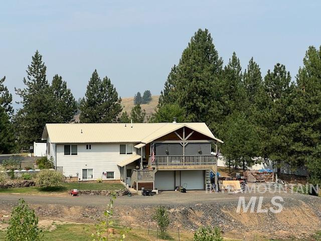 rear view of house featuring a garage