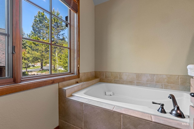 bathroom featuring tiled tub