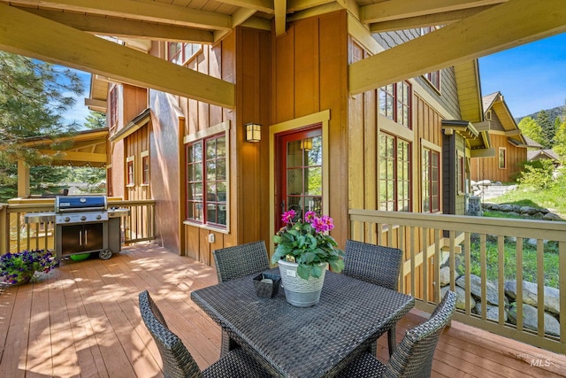 wooden terrace featuring a grill