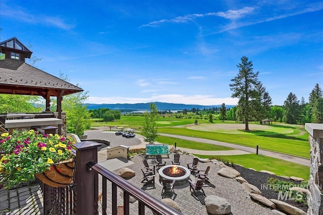 exterior space featuring a gazebo, a mountain view, and a fire pit