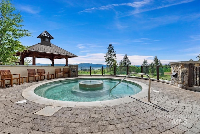 view of pool with a gazebo and a mountain view