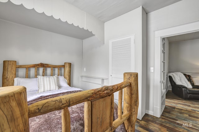 bedroom with dark wood-type flooring