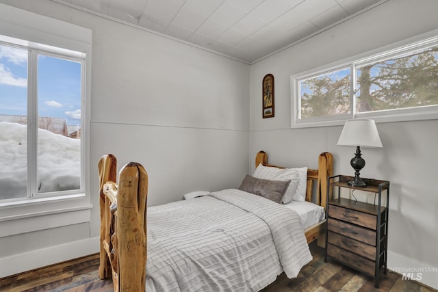 bedroom with dark wood finished floors