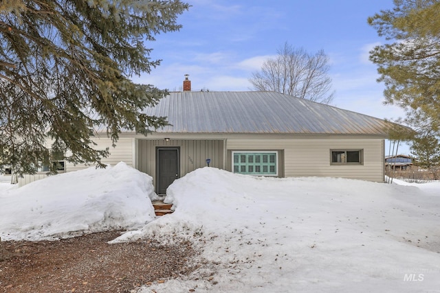 exterior space with metal roof and a chimney